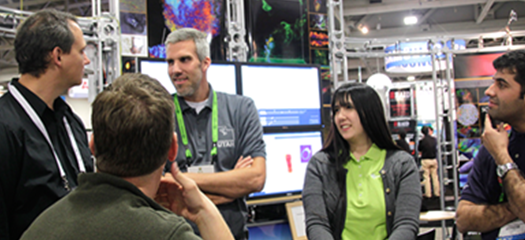 people talking at a conference booth