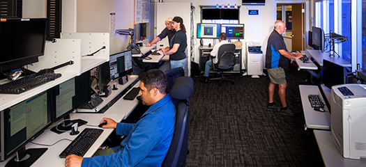 LC staff working inside the control room