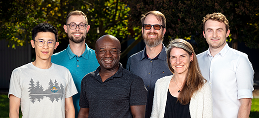 six people pose as a group