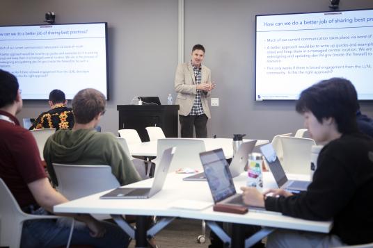 Erik Draeger is giving a presentation to hackathon attendees.