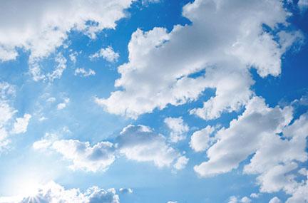 Scattered fluffy clouds in the sky.