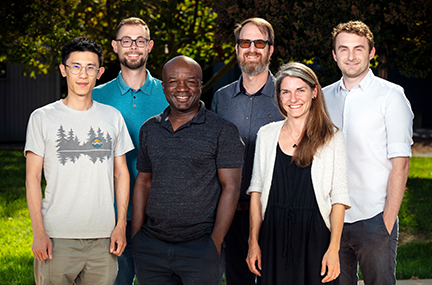 six people pose as a group