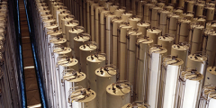 Hundreds of tall cylinders arranged pair-wise in rows, photographed from an elevated vantage point