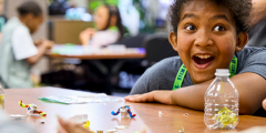 a child looks in wonder at a science demo