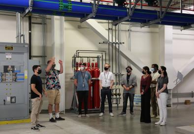 interns on a guided tour beneath the machine room